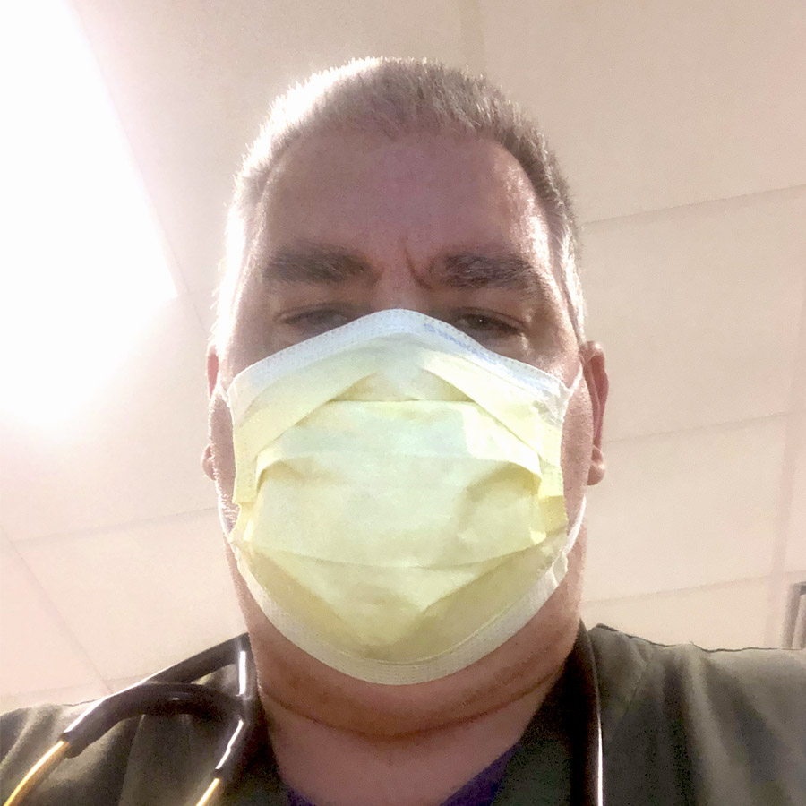 Timothy working as a respiratory therapist, wearing a mask
