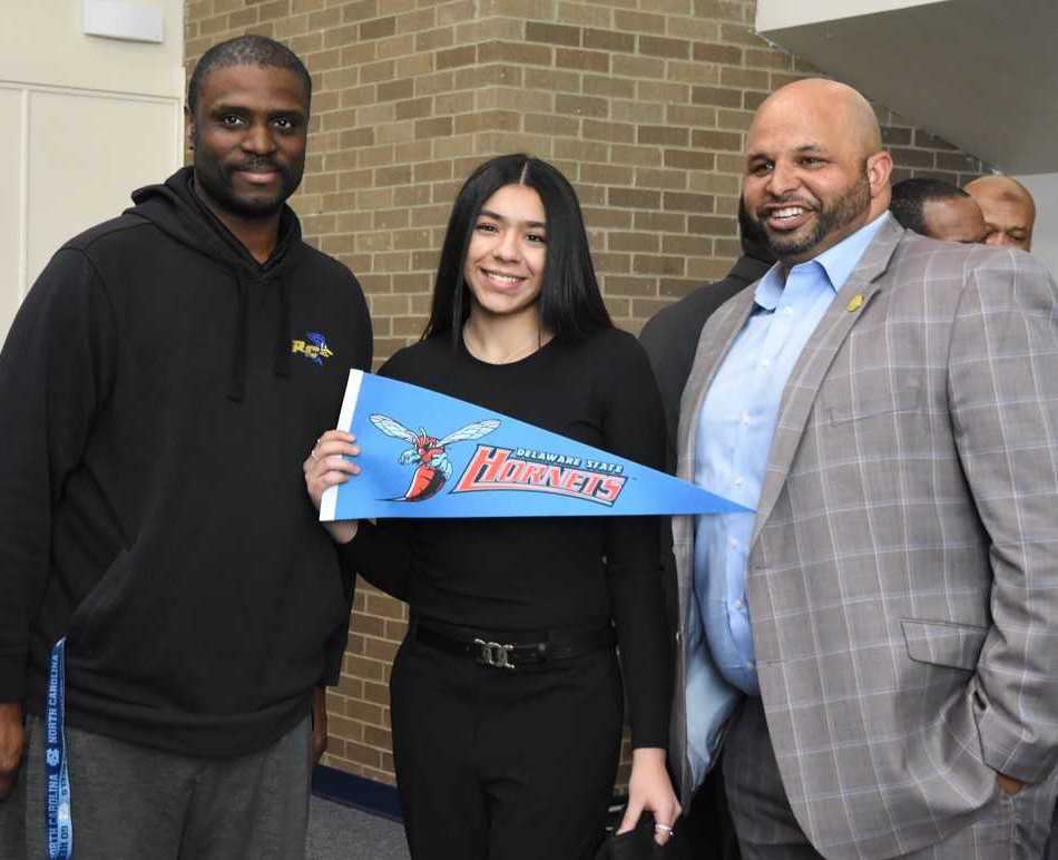 Jinelys Alvarez flies her soon-to-be new school colors with Rich Cooper (left), RCSJ assistant AD and head women’s basketball co