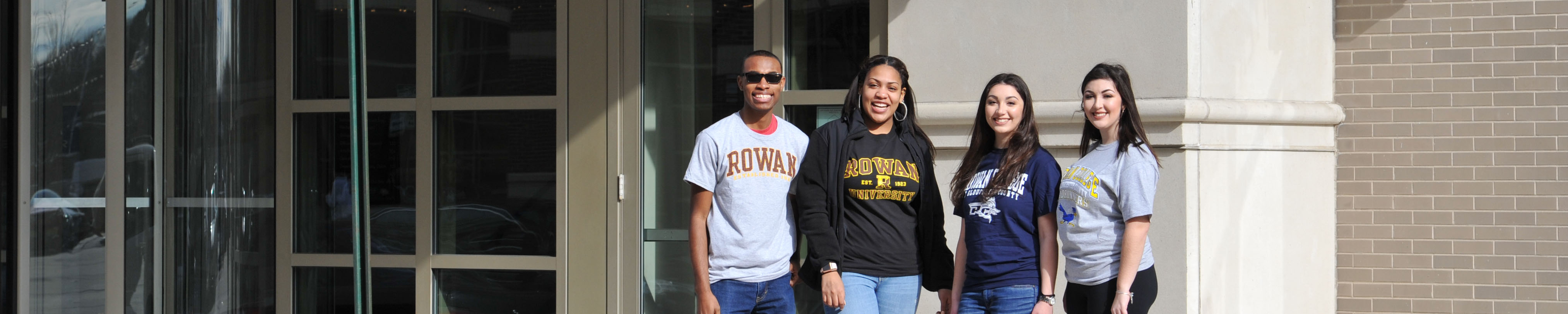 Students with RCSJ t-shirts along with Students with Rowan University standing outside