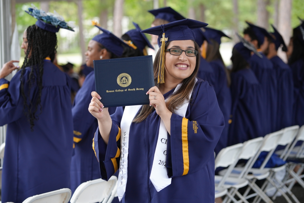 Woman smiling and holding diploma